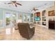 Spacious living room with tile floors,reclining chairs, and access to a balcony at 8731 Betty St, Port Richey, FL 34668