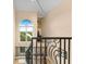 Stunning staircase with wrought iron railing and water views at 8731 Betty St, Port Richey, FL 34668
