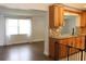 Bright dining area with hardwood floors and view into kitchen at 9705 45Th N Way, Pinellas Park, FL 33782