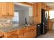 Updated kitchen with granite countertops, modern appliances, and wood cabinets at 9705 45Th N Way, Pinellas Park, FL 33782