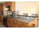 Modern kitchen with granite countertops and wood cabinets at 9705 45Th N Way, Pinellas Park, FL 33782