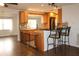 Updated kitchen with wood cabinets, granite counters, breakfast bar, and pet gate at 9705 45Th N Way, Pinellas Park, FL 33782