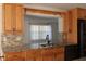 Kitchen with granite counters, wood cabinets, and breakfast bar at 9705 45Th N Way, Pinellas Park, FL 33782