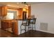 Updated kitchen with wood cabinets, granite counters, breakfast bar, and pet gate at 9705 45Th N Way, Pinellas Park, FL 33782