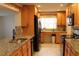 Updated kitchen with granite countertops, modern appliances, and wood cabinets at 9705 45Th N Way, Pinellas Park, FL 33782