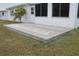Elevated patio with brick pavers and a lush green lawn at 9705 45Th N Way, Pinellas Park, FL 33782