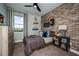 Stylish bedroom with brick feature wall and modern decor at 10237 Fieldstone Myrtle Way, San Antonio, FL 33576
