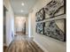 Bright hallway with wood flooring and modern wall art at 10237 Fieldstone Myrtle Way, San Antonio, FL 33576