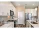 Modern kitchen with white cabinets and stainless steel appliances at 10237 Fieldstone Myrtle Way, San Antonio, FL 33576