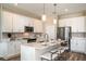 Modern kitchen with white cabinets, stainless steel appliances, and an island at 10237 Fieldstone Myrtle Way, San Antonio, FL 33576