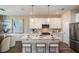 Modern kitchen with white cabinets, stainless steel appliances, and an island at 10237 Fieldstone Myrtle Way, San Antonio, FL 33576