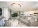 Open living area with gray sectional sofa and view to kitchen at 10237 Fieldstone Myrtle Way, San Antonio, FL 33576
