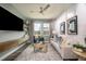 Comfortable living room featuring a cozy sofa and large TV at 10237 Fieldstone Myrtle Way, San Antonio, FL 33576