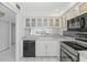 Modern white kitchen with stainless steel appliances at 105 Island Way # 146, Clearwater, FL 33767