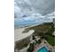 Aerial view showcasing beach, pool, and resort amenities at 1270 Gulf Blvd # 1206, Clearwater Beach, FL 33767