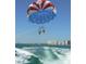 Parasailing over the ocean with cityscape views at 1270 Gulf Blvd # 1206, Clearwater Beach, FL 33767