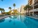 Sparkling community pool with surrounding lounge chairs at 1270 Gulf Blvd # 1206, Clearwater Beach, FL 33767