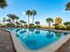 Relaxing community pool with palm trees and lounge chairs at 1270 Gulf Blvd # 1206, Clearwater Beach, FL 33767