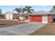 House with detached workshop and red garage door at 13101 Delbarton St, Spring Hill, FL 34609