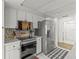 Modern kitchen with stainless steel appliances and white cabinets at 13101 Delbarton St, Spring Hill, FL 34609