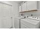 Laundry room with washer, dryer, and cabinets at 13101 Delbarton St, Spring Hill, FL 34609