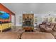 Living room with stone fireplace and large TV at 13101 Delbarton St, Spring Hill, FL 34609