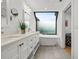 Modern bathroom with a soaking tub, double vanity, and a large window at 162 E Davis Blvd, Tampa, FL 33606