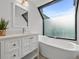 Updated bathroom featuring a freestanding tub and a large window at 162 E Davis Blvd, Tampa, FL 33606
