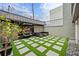 Artificial turf and stone courtyard with seating area at 162 E Davis Blvd, Tampa, FL 33606