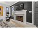 Modern fireplace with white tile surround and dark wall accent at 162 E Davis Blvd, Tampa, FL 33606
