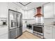 Modern kitchen features stainless steel appliances and white cabinets at 162 E Davis Blvd, Tampa, FL 33606