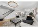 Open living area with sectional sofa, ottoman, and view of upper level at 162 E Davis Blvd, Tampa, FL 33606