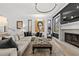 Light and airy living room featuring a fireplace, sectional sofa, and large artwork at 162 E Davis Blvd, Tampa, FL 33606