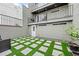 Ground level patio with artificial turf and stone design at 162 E Davis Blvd, Tampa, FL 33606