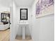 Elegant powder room features a pedestal sink, and modern fixtures at 162 E Davis Blvd, Tampa, FL 33606