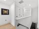 Modern staircase with light-colored wood floors and white walls at 162 E Davis Blvd, Tampa, FL 33606