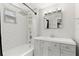 Bathroom with white subway tiles, gray vanity, and bathtub at 1654 50Th N Ave, St Petersburg, FL 33714