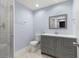 Bathroom with gray vanity, white subway tiles, and patterned floor at 1654 50Th N Ave, St Petersburg, FL 33714