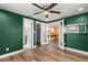 Spacious bedroom with hardwood floors and green walls at 1654 50Th N Ave, St Petersburg, FL 33714