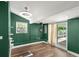 Bright bonus room with wood-look floors and sliding glass door access to the patio at 1654 50Th N Ave, St Petersburg, FL 33714