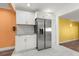 Bright kitchen with stainless steel refrigerator and white cabinetry at 1654 50Th N Ave, St Petersburg, FL 33714