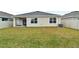 Spacious backyard with grassy area and a covered patio at 17019 Avon Dive Ln, Wimauma, FL 33598
