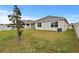 Large backyard with grassy lawn, and a covered patio at 17019 Avon Dive Ln, Wimauma, FL 33598