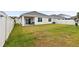 Large backyard with grassy area and a covered patio with grill at 17019 Avon Dive Ln, Wimauma, FL 33598