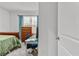 Bedroom with wooden dresser, desk, and green bedding at 17019 Avon Dive Ln, Wimauma, FL 33598