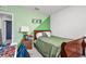 Bedroom with green walls and wooden sleigh bed at 17019 Avon Dive Ln, Wimauma, FL 33598