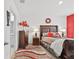 Spacious bedroom with a large bed and red accent wall at 17019 Avon Dive Ln, Wimauma, FL 33598