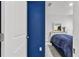 Bedroom with a blue wall and a glimpse of the bed at 17019 Avon Dive Ln, Wimauma, FL 33598