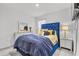 Bedroom with blue velvet headboard and yellow pillows at 17019 Avon Dive Ln, Wimauma, FL 33598