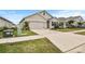 Two-story house with a two-car garage, driveway, and front yard at 17019 Avon Dive Ln, Wimauma, FL 33598